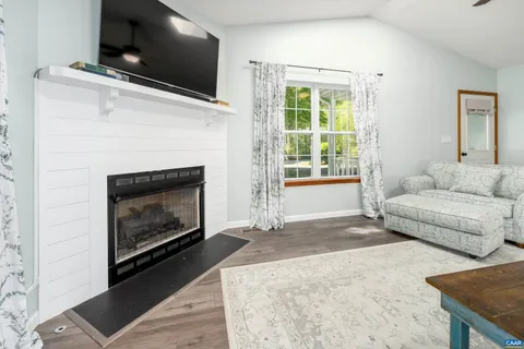 a living room with a flat screen tv and a fireplace