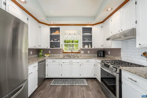 a kitchen with stainless steel appliances a stove sink and cabinets