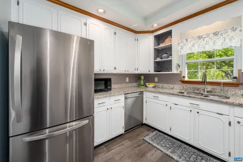 a kitchen with stainless steel appliances a refrigerator sink and cabinets