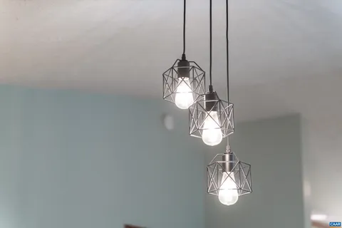 a view of a room with a chandelier fan and a rug