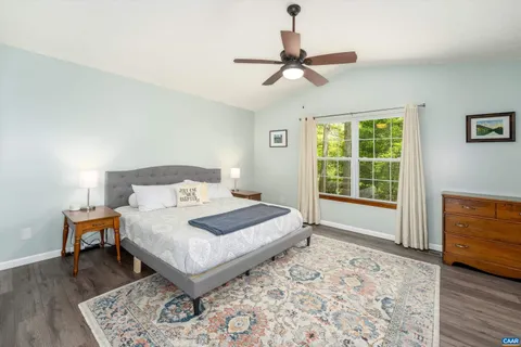 a bedroom with a large bed and a window