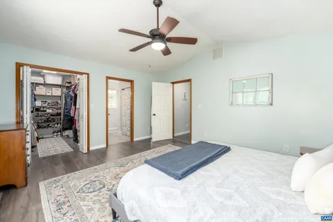 a bedroom with a large bed and a chandelier