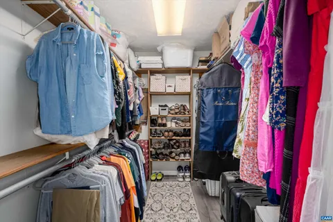 a view of walk in closet with clothes