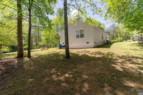 a backyard of a house with a tree