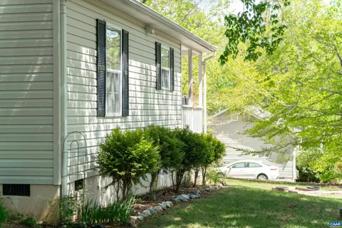 a view of a house with a yard and plants