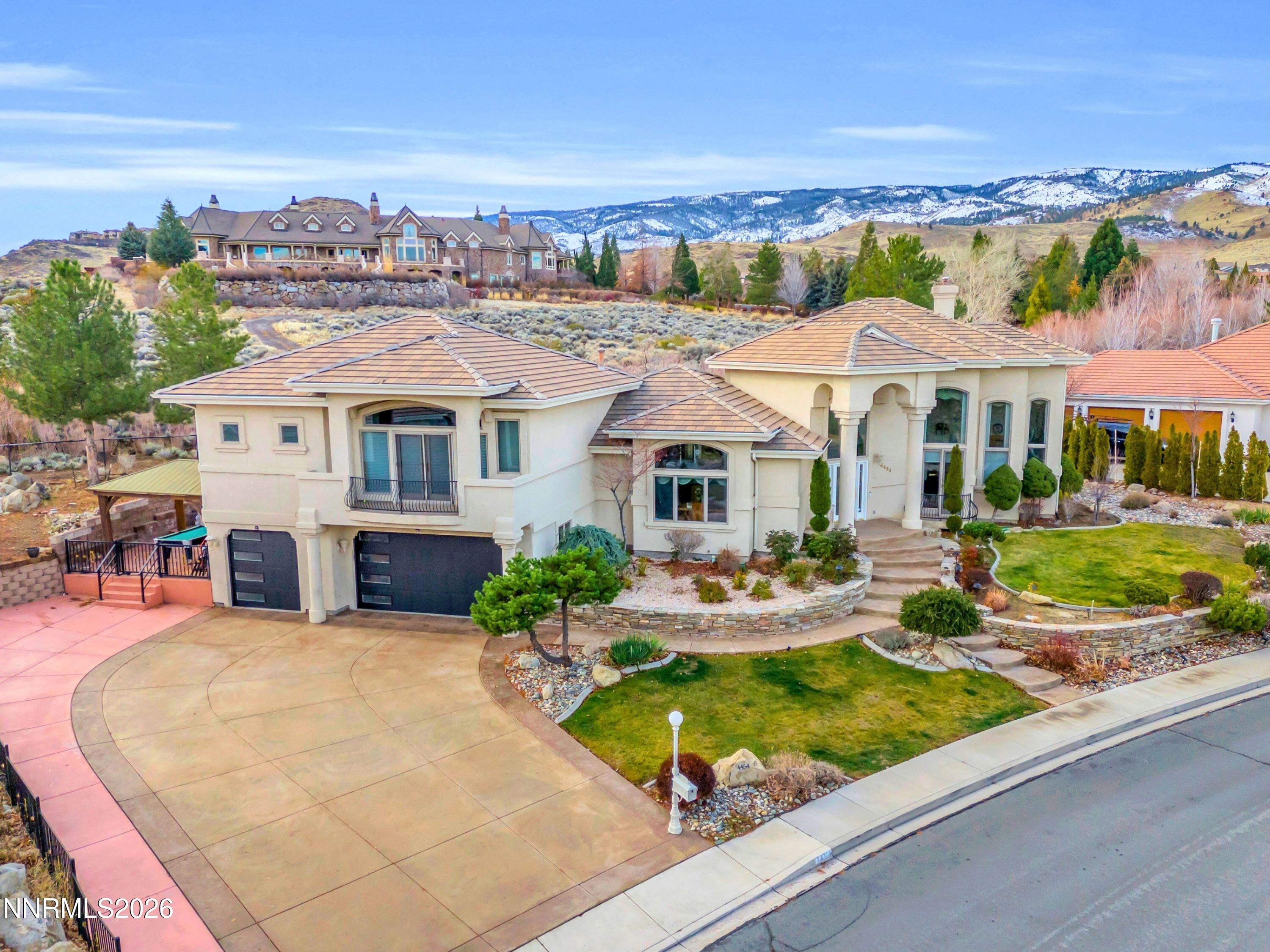 an aerial view of a house with swimming pool patio and outdoor seating
