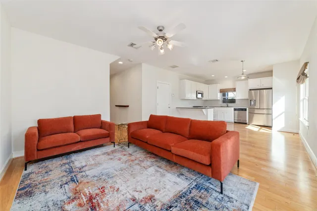 a living room with furniture and kitchen view