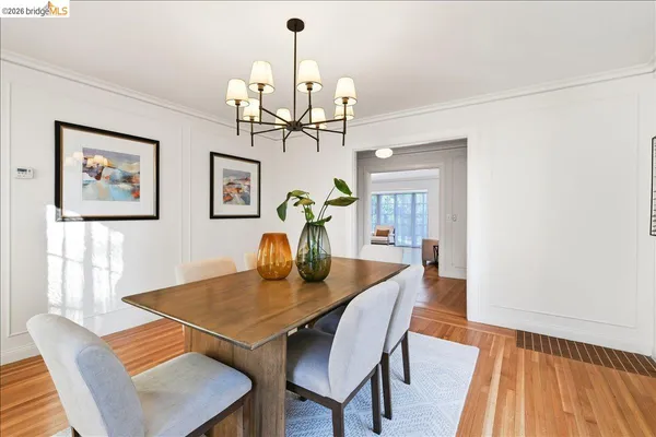 a view of a dining room with furniture wooden floor and chandelier