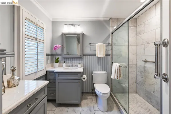 a bathroom with a sink vanity granite and a mirror