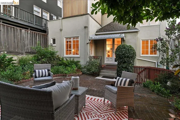 a view of a backyard with a sitting area and a garden