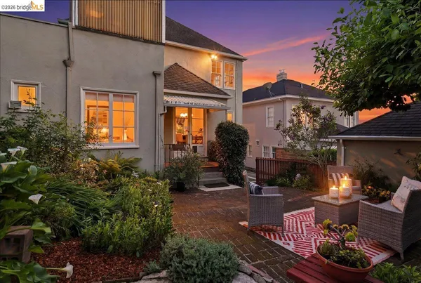 a backyard of a house with table and chairs