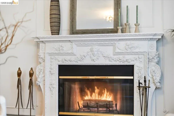 a fireplace with a clock on wall