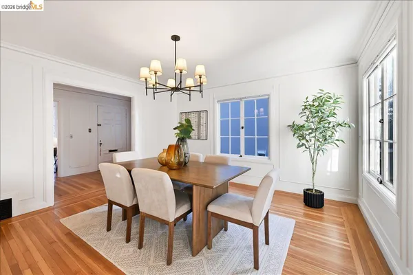 a view of a dining room with furniture wooden floor and chandelier