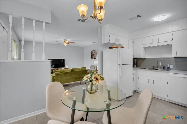 a kitchen with stainless steel appliances granite countertop a table and a microwave