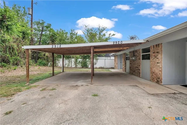 a view of a house with a backyard and balcony
