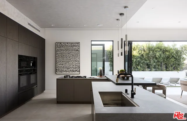 a living room with furniture and large windows