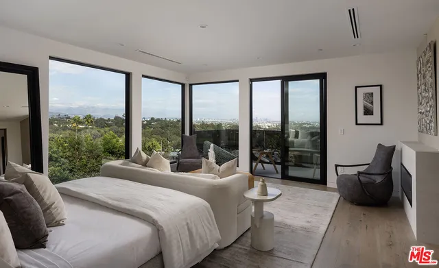 a bedroom with a bed and a large window