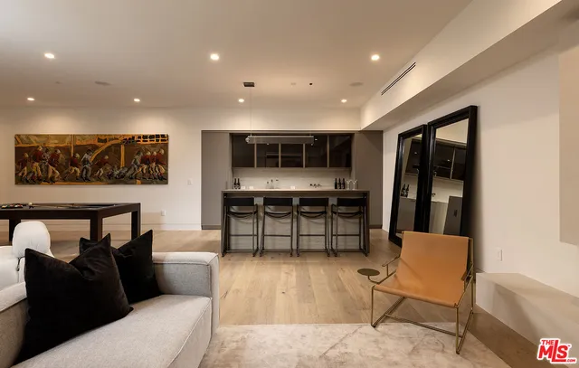 a living room with furniture and a floor to ceiling window