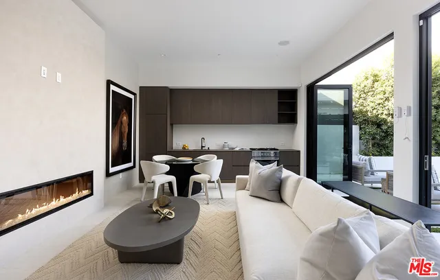 a living room with pool table and sofas