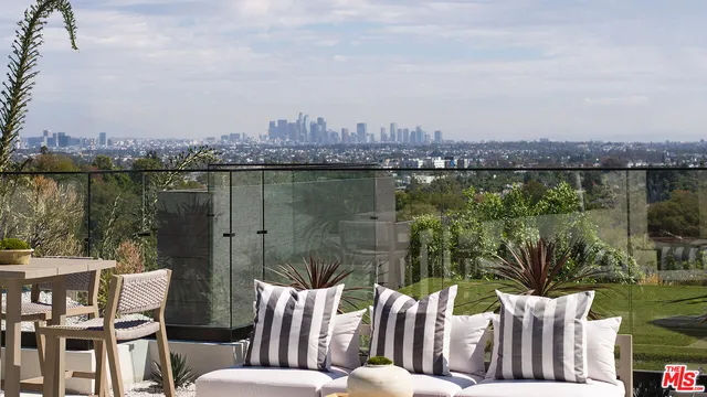 a view of a lake from a balcony with outdoor seating