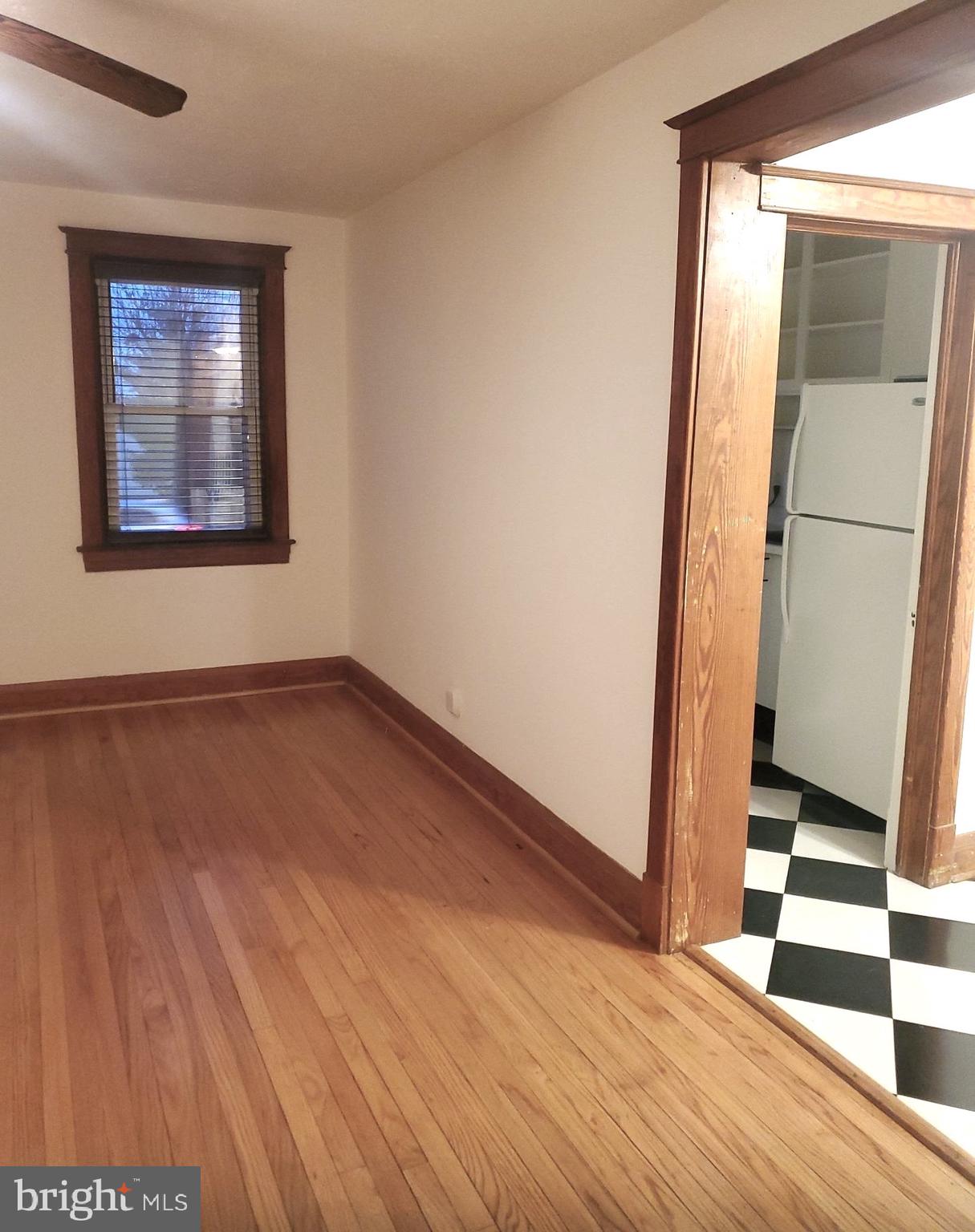 8000 Harford Road Parkville, MD 21234 - Photo 12 of 20 an empty room with wooden floor and a window