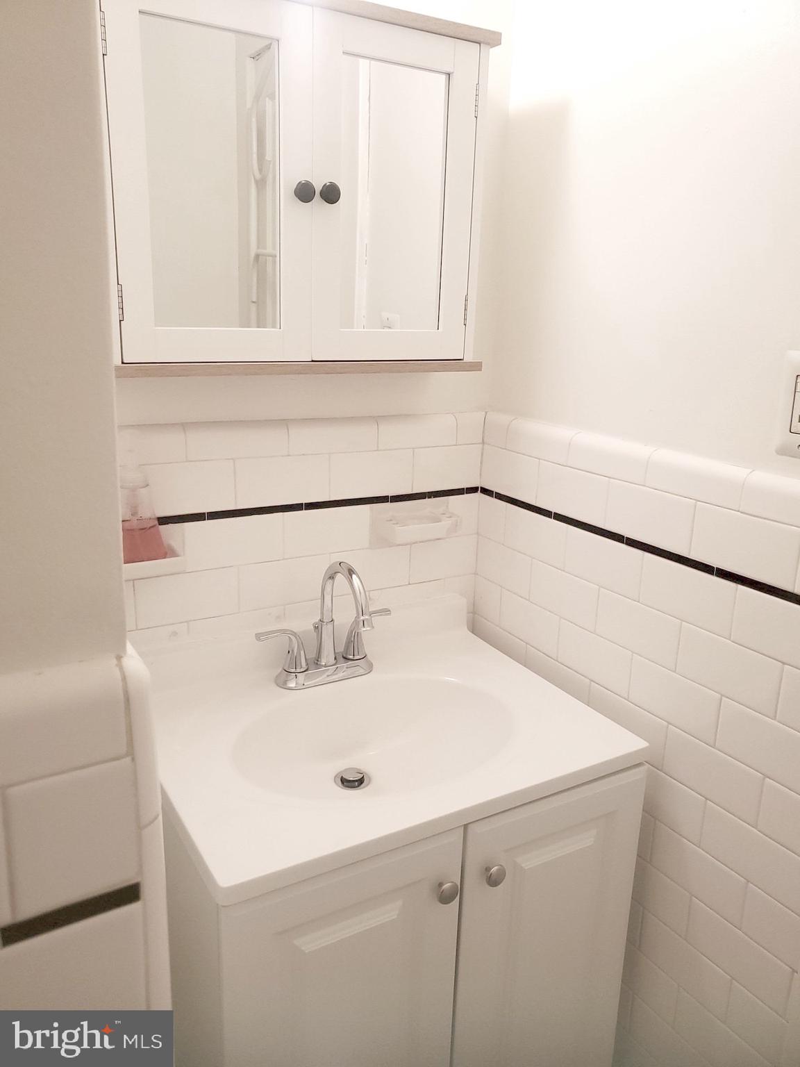 8000 Harford Road Parkville, MD 21234 - Photo 14 of 20 a bathroom with a sink and a mirror