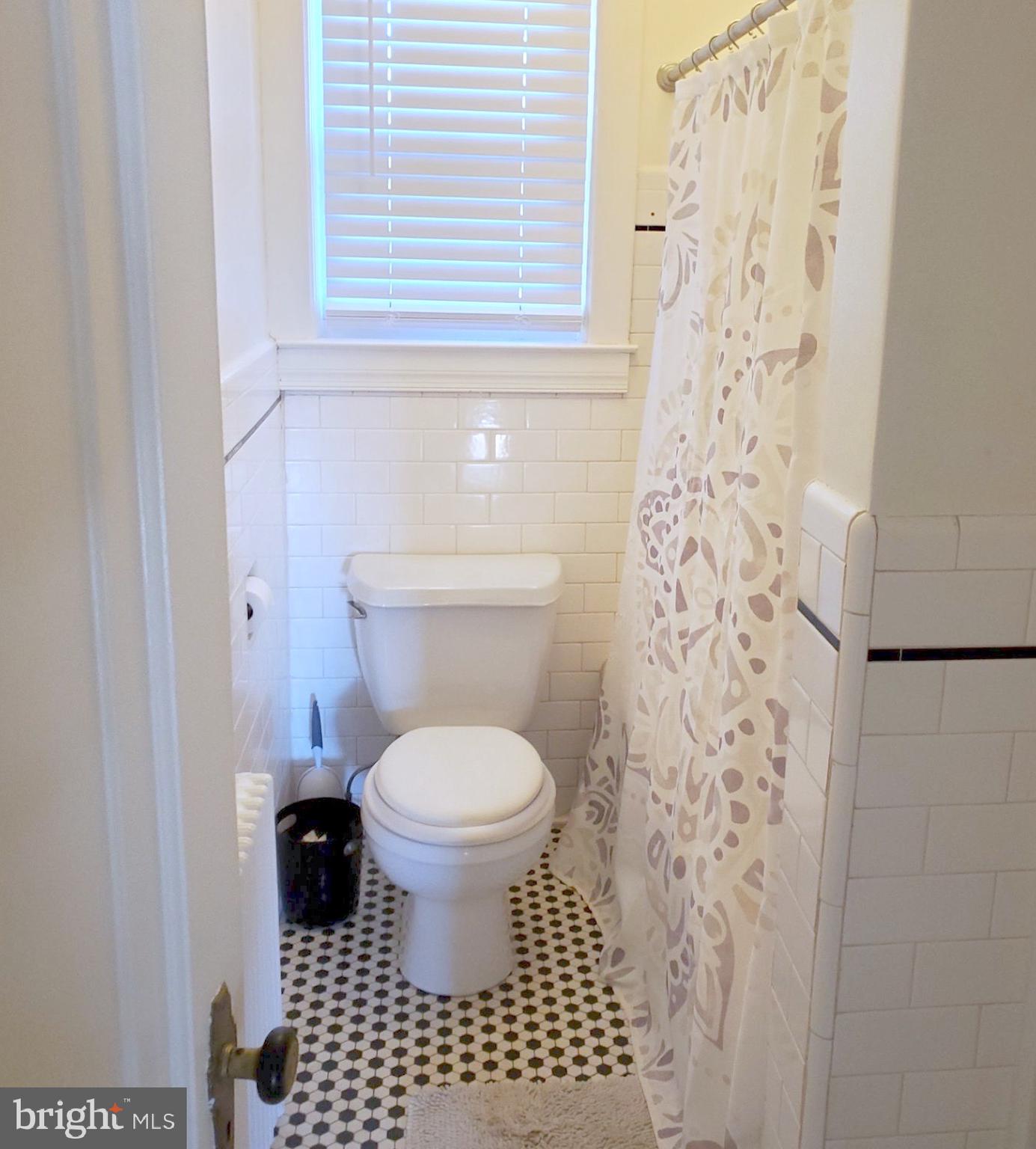 8000 Harford Road Parkville, MD 21234 - Photo 15 of 20 a bathroom with a toilet and a shower curtain