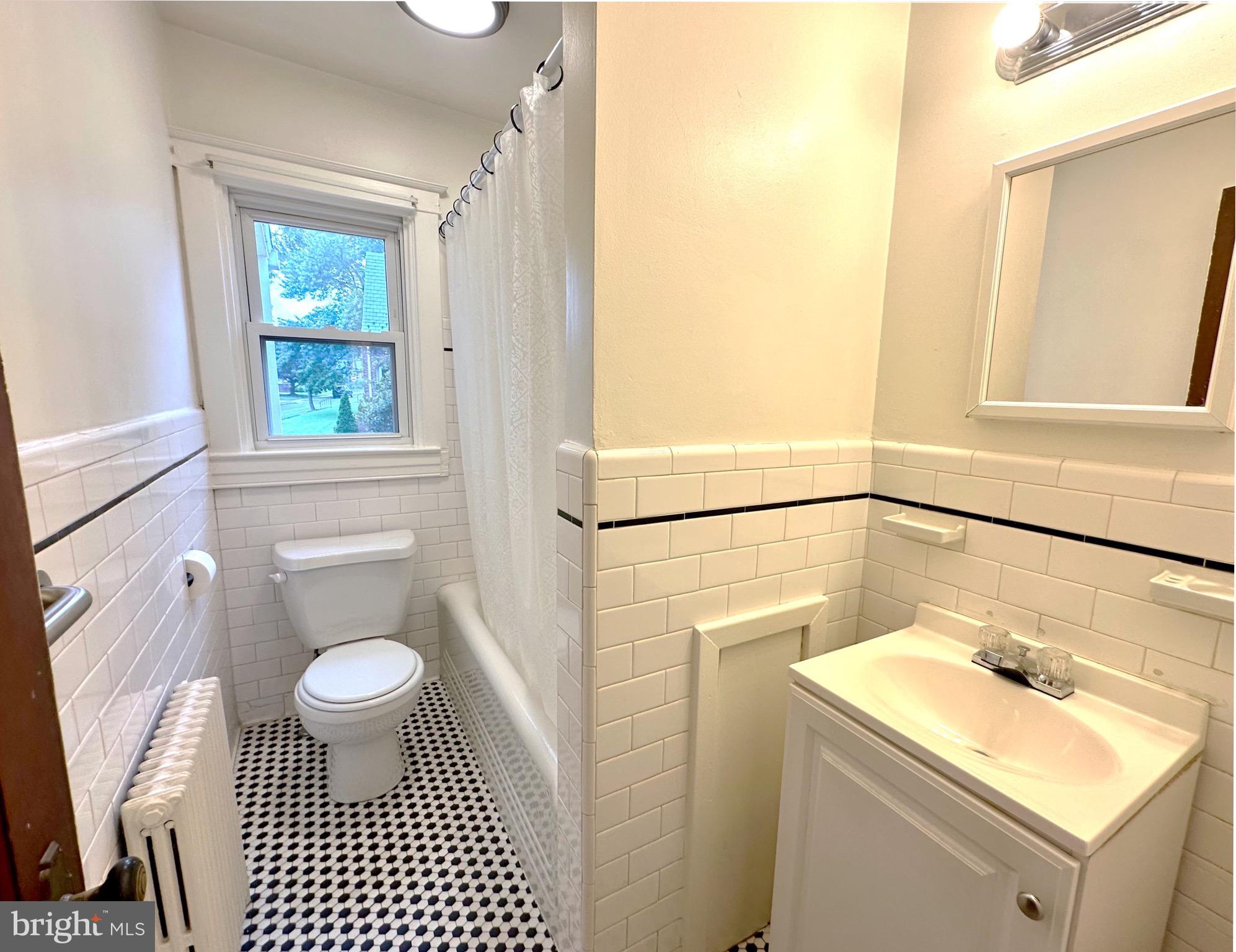 8000 Harford Road Parkville, MD 21234 - Photo 7 of 20 a bathroom with a sink toilet and window