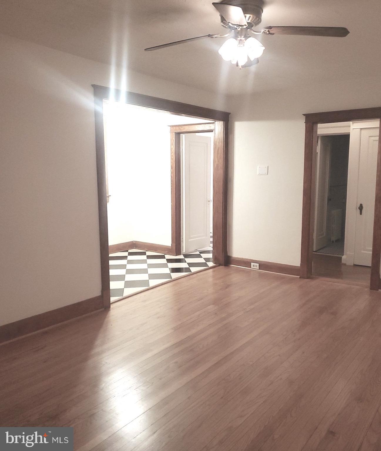 8000 Harford Road Parkville, MD 21234 - Photo 10 of 20 an empty room with wooden floor fan and windows