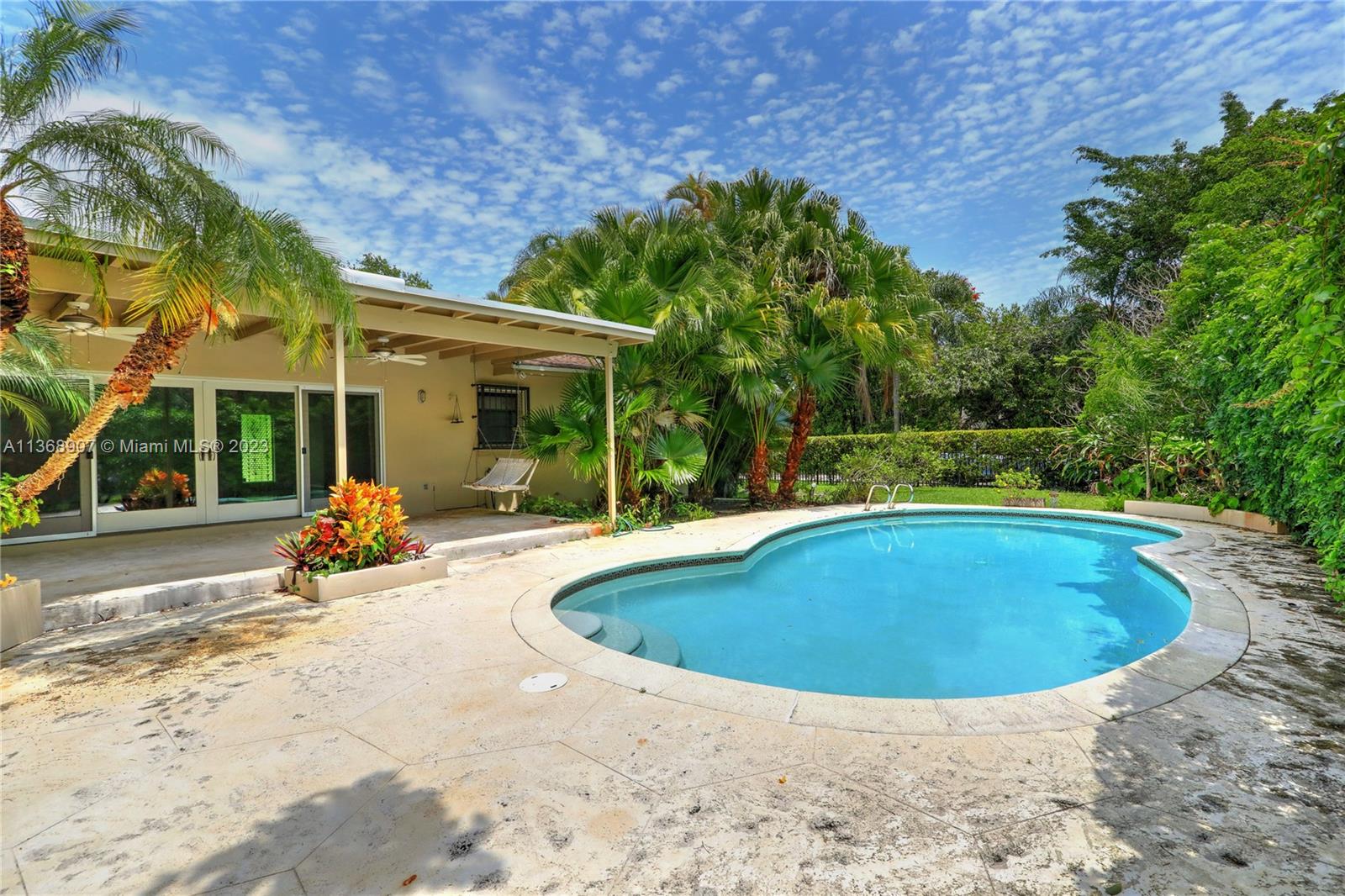 6970 Sunset Drive Miami, FL 33143 - Photo 2 of 30 a view of a swimming pool with a patio