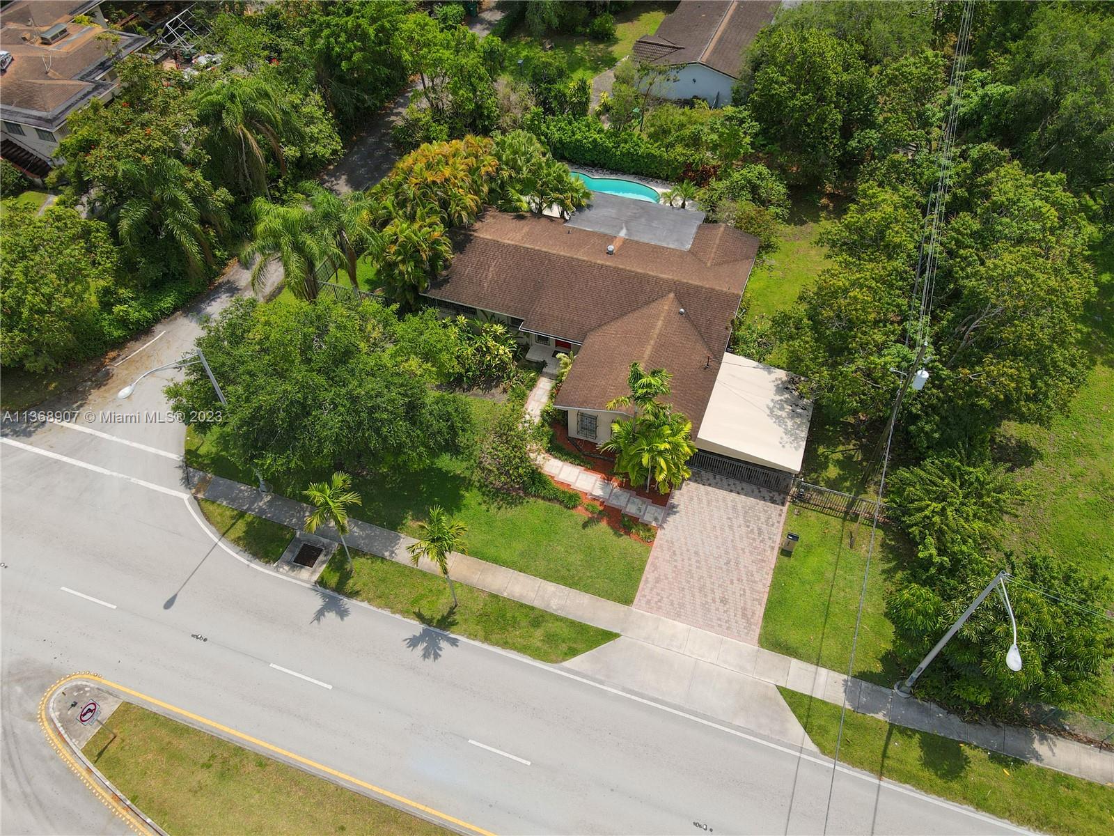 6970 Sunset Drive Miami, FL 33143 - Photo 23 of 30 an aerial view of a house with garden space and street view