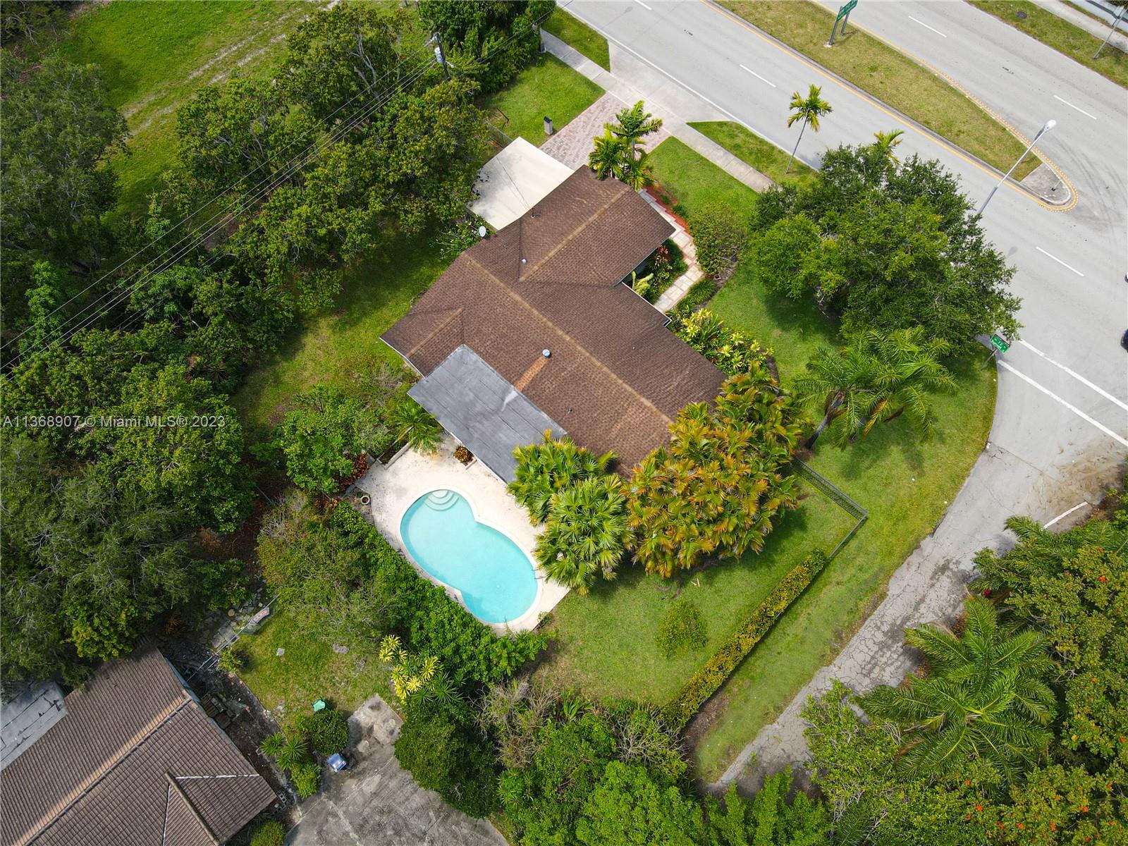 6970 Sunset Drive Miami, FL 33143 - Photo 24 of 30 an aerial view of a house with a yard and swimming pool