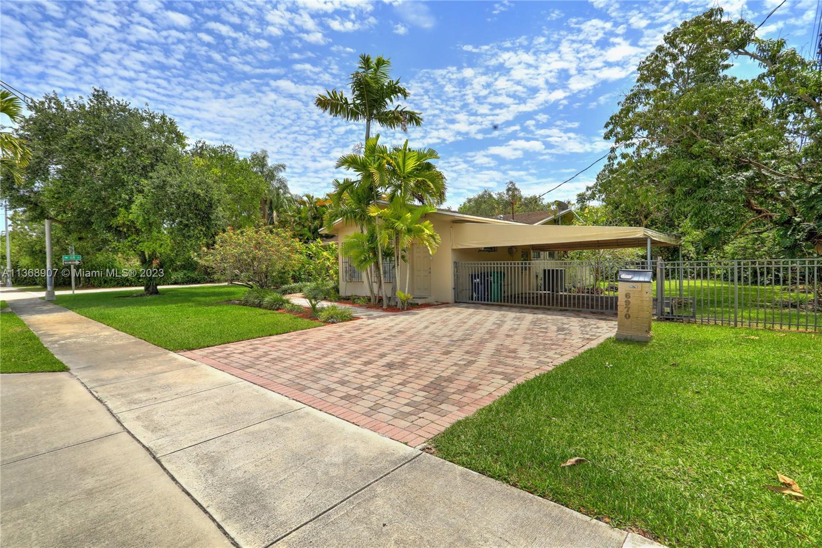6970 Sunset Drive Miami, FL 33143 - Photo 27 of 30 a house with garden in front of it