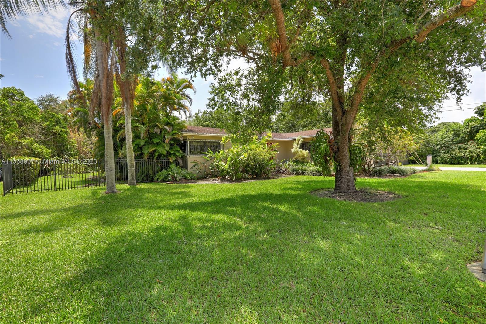 6970 Sunset Drive Miami, FL 33143 - Photo 28 of 30 a view of backyard of house with green space