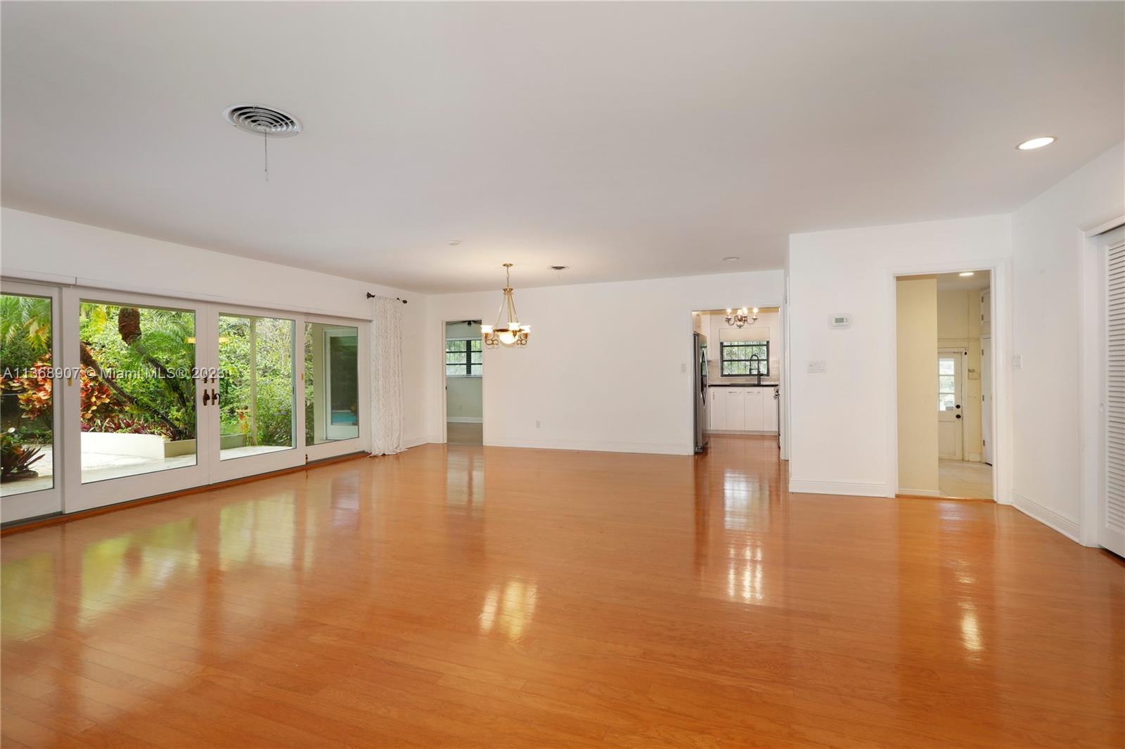 6970 Sunset Drive Miami, FL 33143 - Photo 4 of 30 a view of empty room with wooden floor and fan