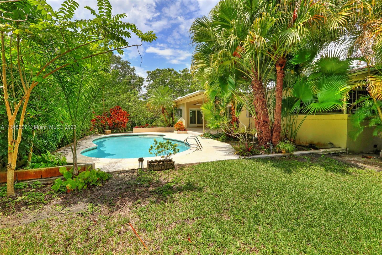 6970 Sunset Drive Miami, FL 33143 - Photo 5 of 30 a view of a house with backyard and sitting area