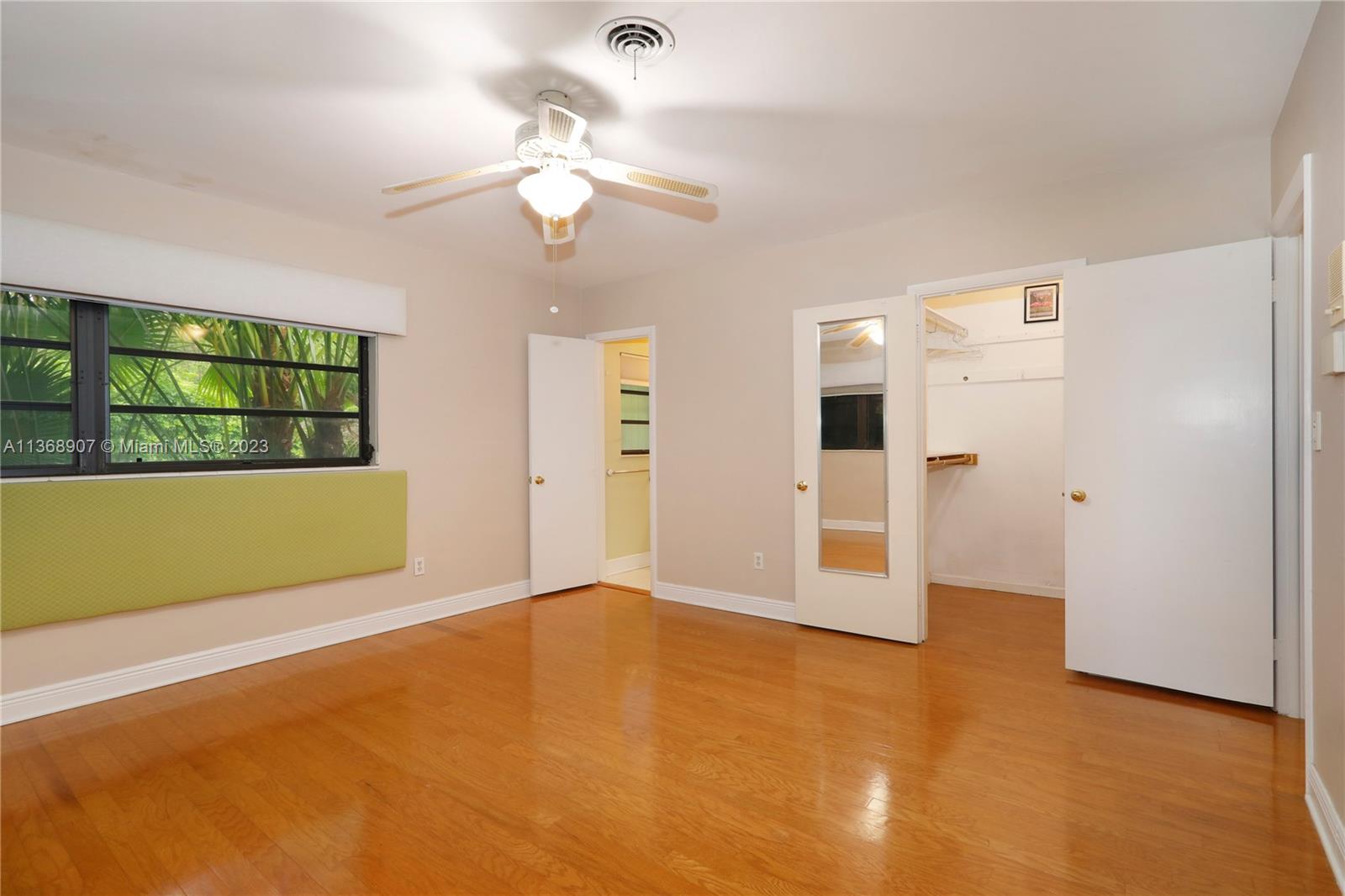 6970 Sunset Drive Miami, FL 33143 - Photo 8 of 30 a view of an empty room with a fireplace and chandelier
