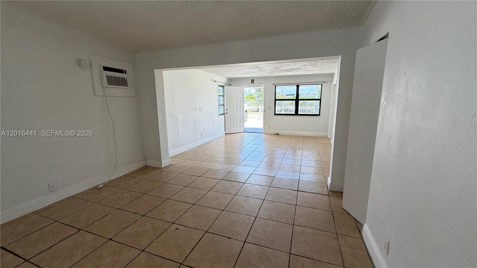 2230 Service Road Opa-Locka, FL 33054 - Photo 14 of 25 a view of an empty room with window and wooden floor