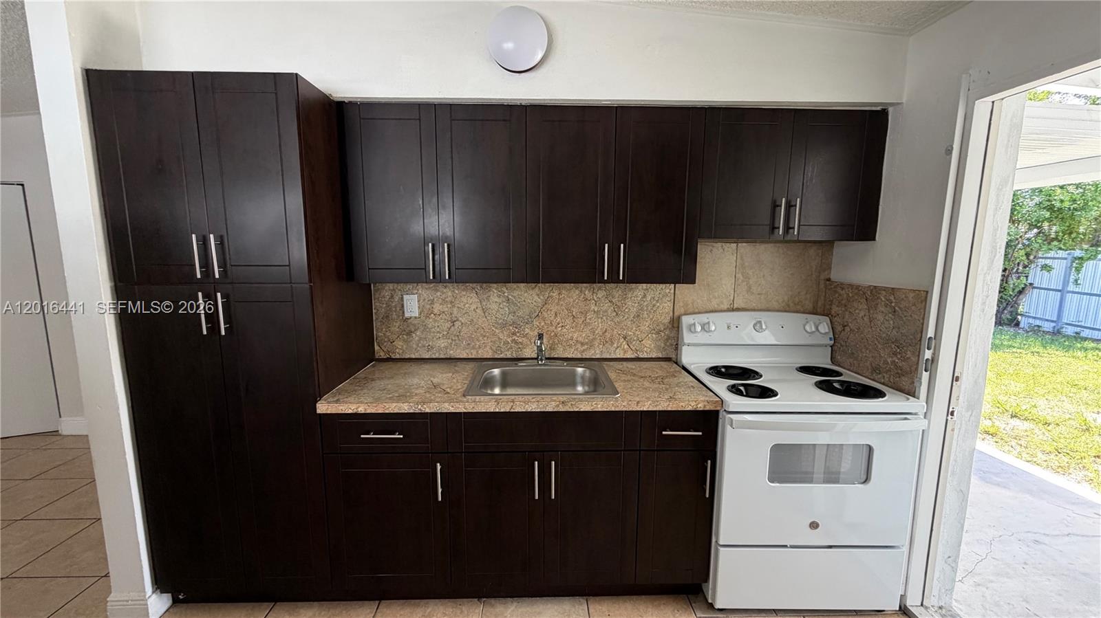2230 Service Road Opa-Locka, FL 33054 - Photo 16 of 25 a kitchen with a sink a stove and refrigerator