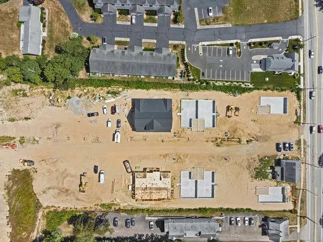 an aerial view of residential houses with outdoor space