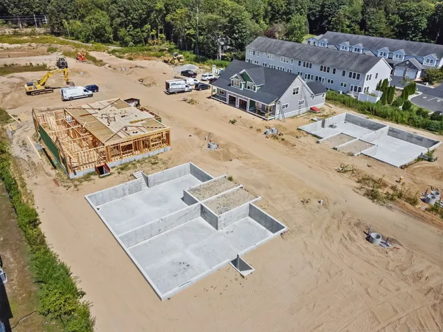 an aerial view of a residential building with an outdoor space