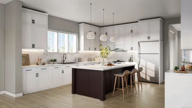 a kitchen with granite countertop a sink cabinets and wooden floor