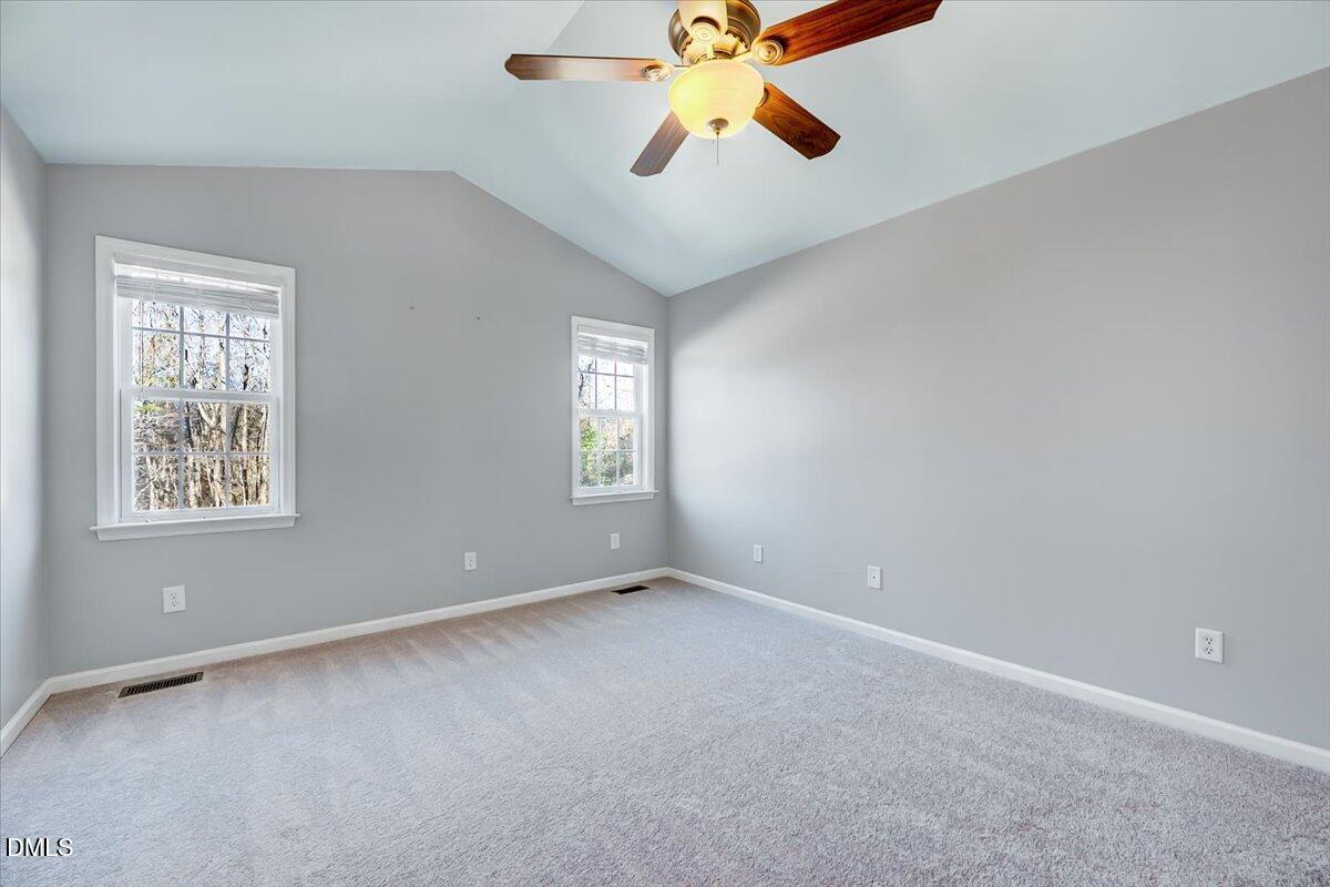 1716 Middle Ridge Drive Willow Spring, NC 27592 - Photo 17 of 41 an empty room with windows and fan