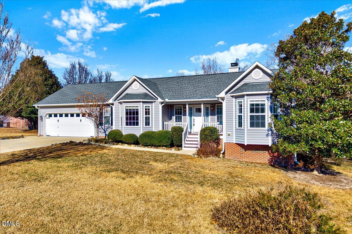 1716 Middle Ridge Drive Willow Spring, NC 27592 - Photo 2 of 41 a front view of a house with a yard
