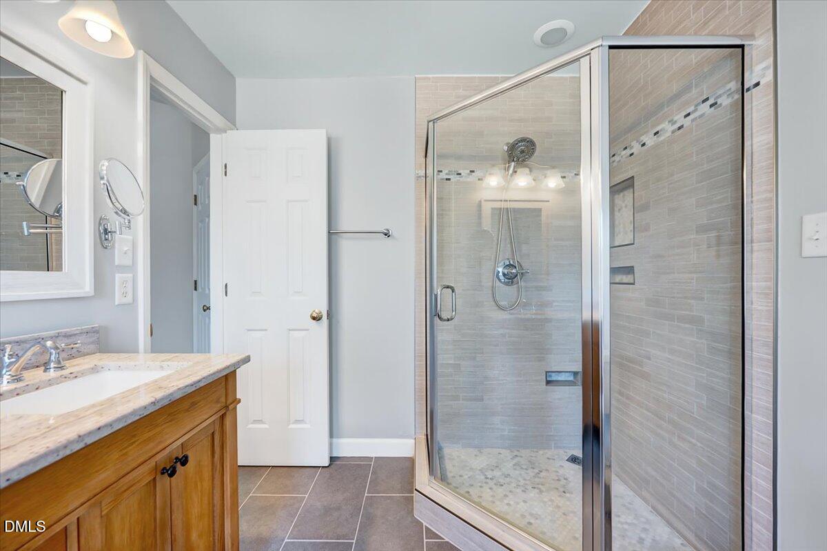 1716 Middle Ridge Drive Willow Spring, NC 27592 - Photo 21 of 41 a bathroom with a granite countertop shower sink and mirror