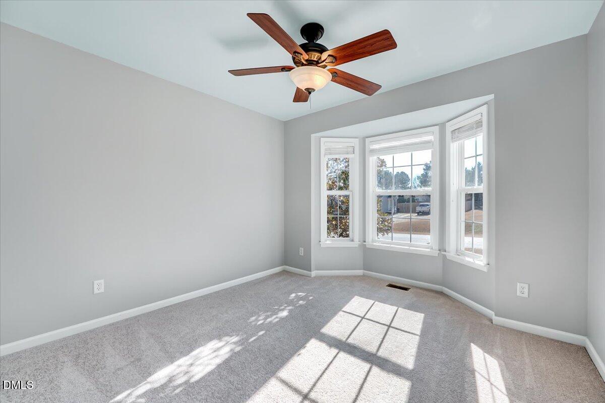 1716 Middle Ridge Drive Willow Spring, NC 27592 - Photo 22 of 41 a view of empty room with wooden floor and fan