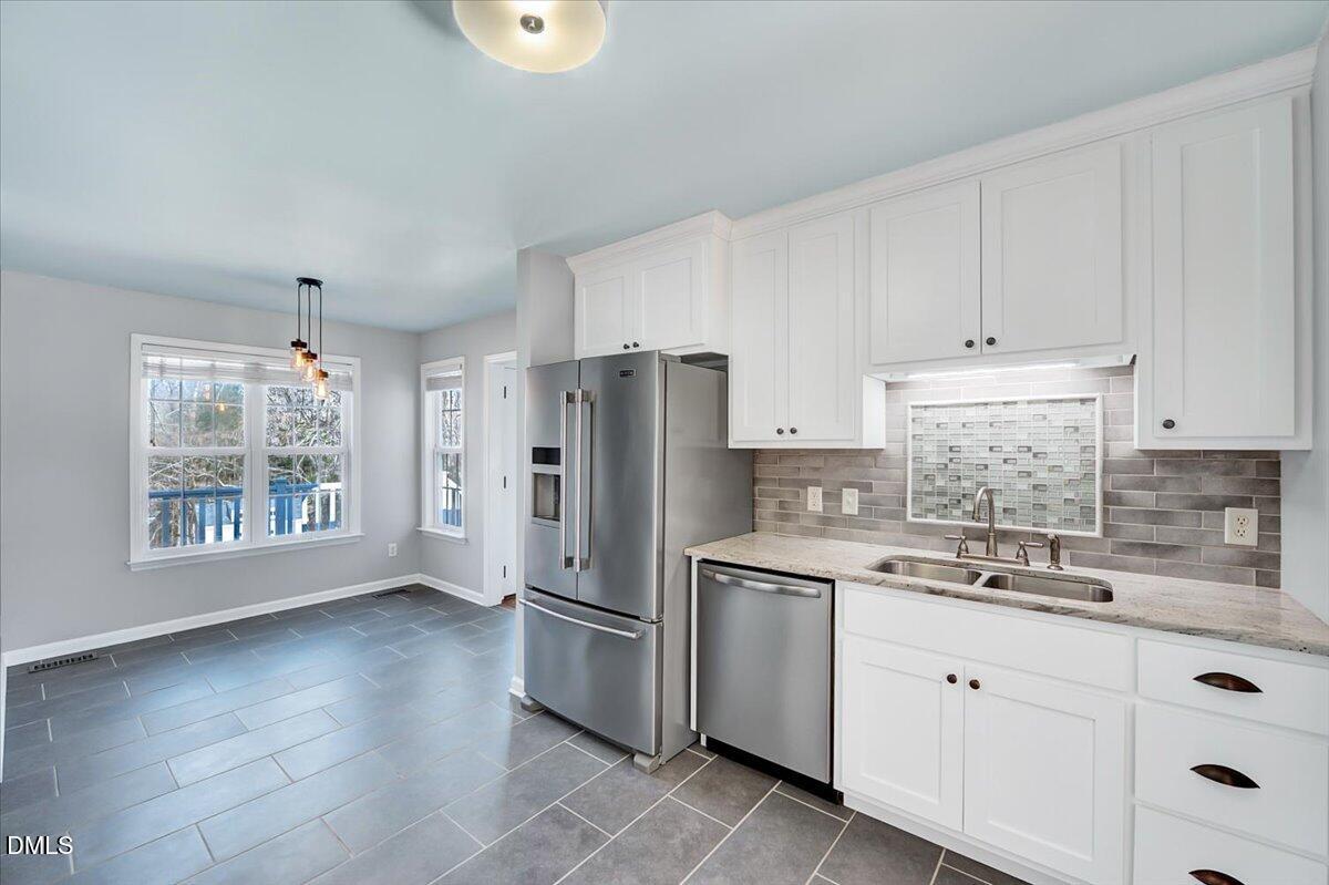 1716 Middle Ridge Drive Willow Spring, NC 27592 - Photo 9 of 41 a kitchen with a refrigerator sink and cabinets
