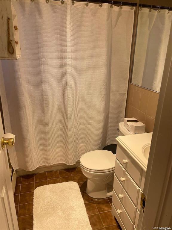 263 River Avenue, Unit 6AU Patchogue, NY 11772 - Photo 11 of 12 a bathroom with a sink and a toilet