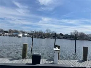a living room with furniture a flat screen tv and a window