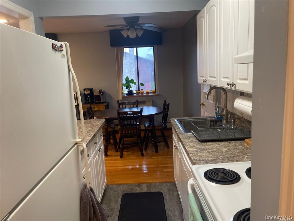 263 River Avenue, Unit 6AU Patchogue, NY 11772 - Photo 7 of 12 a kitchen with stainless steel appliances granite countertop sink stove and refrigerator